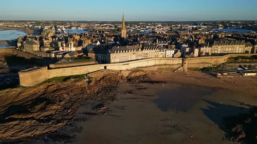 Amazing drone view outside of Intra Muros coastal shoreline at sunset, Saint-Malo, France.