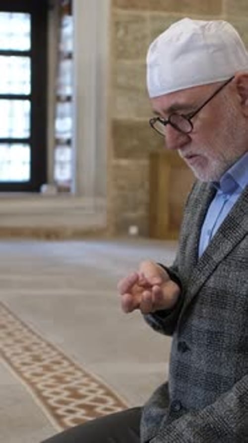 Man Counting in Mosque Praying