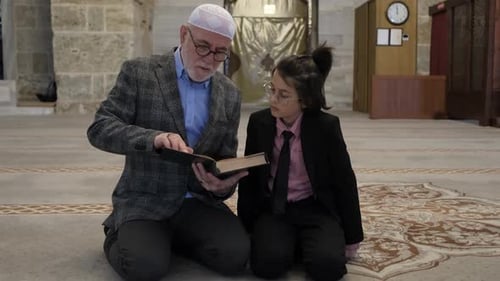 Adult Teaches Child at Mosque