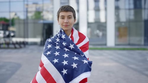 Attractive Caucasian Woman Proudly Representing Her Home Country and Putting USA Flag on Her Back
