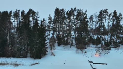 Cabin on stilts in snowy pine forest Tervete Latvia