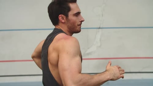 Tired Fitness Man Running Outdoor at Sport Stadium. Male Runner Running Outside