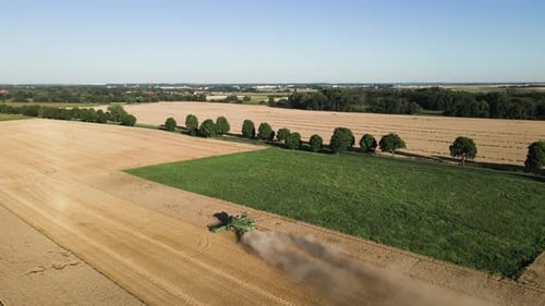 Combine Harvester Working in Wheat Field Aerial View