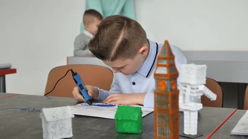 Young Boy Drawing with a 3D Pen