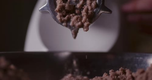 Closeup of Meat Grinding Process Preparing Meat Dishes