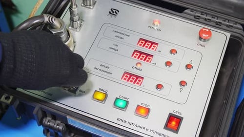 Worker Starts Machine Pressing Buttons on Control Panel