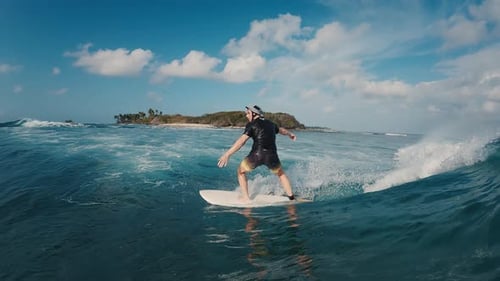 Beginner Surfer Rides the Ocean Wave in the Maldives In Water and Underwater View of the Surfer on