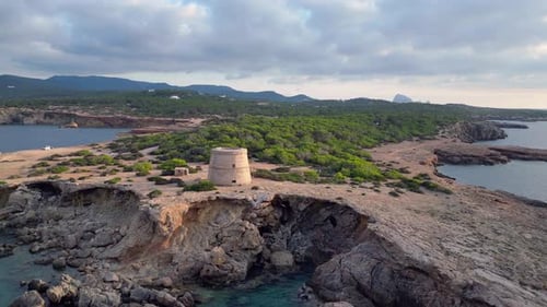 mediterranean coastal sunset ancient historic tower. Spectacular aerial top view flight ascending dr