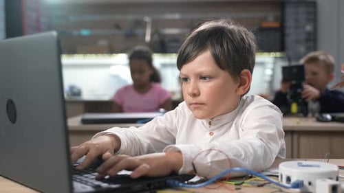 Portrait of Smart Caucasian School Boy Programming
