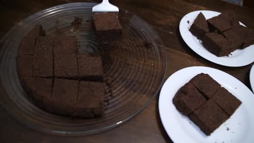 Keto Chocolate Brownie cake being served on three white plates
