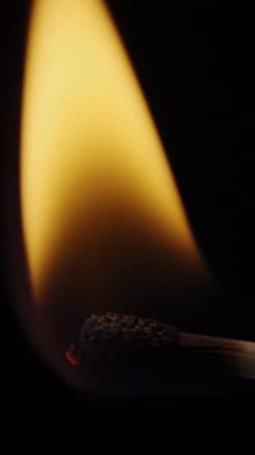 Burning Matchstick Flame Dancing in the Dark