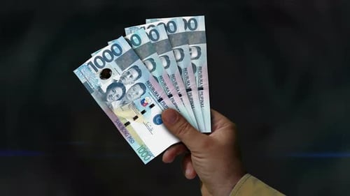 Philippines Peso money fan of banknotes in hand