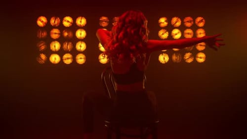 Sensual Woman Dancing Sitting Backwards on Chair Nightclub. Sexy Blonde Performer Making