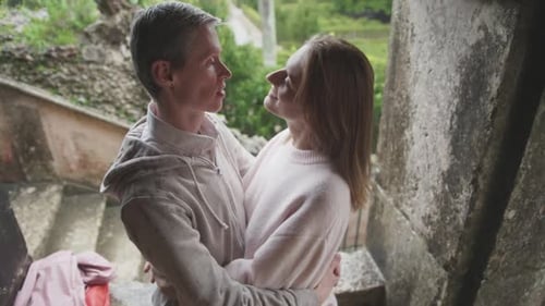 Affectionate Couple Embracing on Stone Stairway