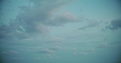 Clouds Drifting Slowly Across a Gradient Blue Sky
