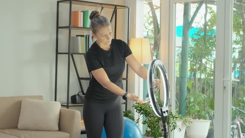 Fitness Blogger Setting Ring Light at Home