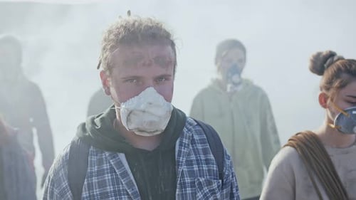 People Wearing Masks Walking Through Dust and Haze