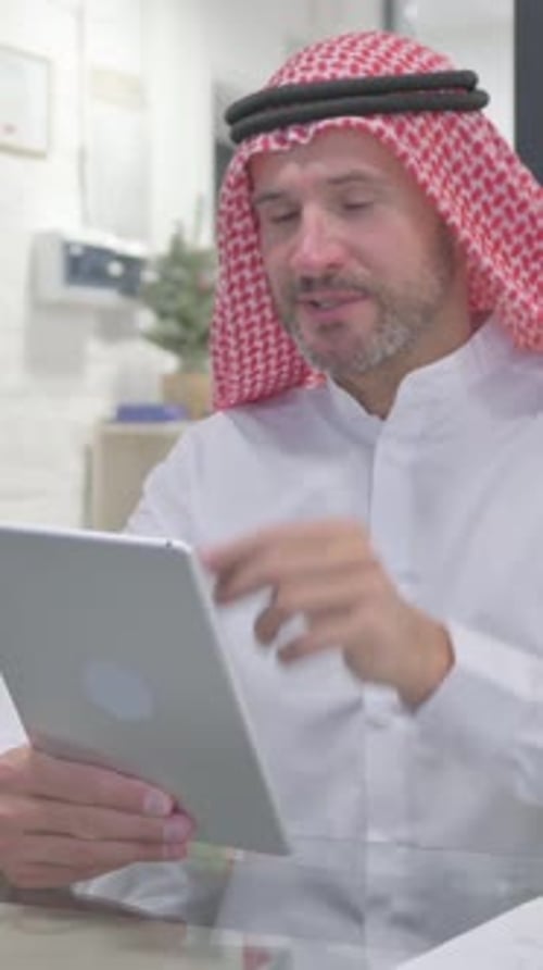Middle Aged Muslim Man Doing Video Chat on Tablet in Office, vertical video
