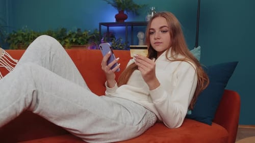 Lovely Girl Using Credit Bank Card and Smartphone Transferring Money Purchases Online Shopping