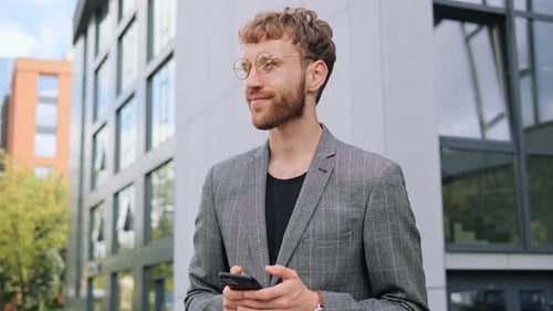 Close Up of Young Happy Businessman Texting Message in Social Media