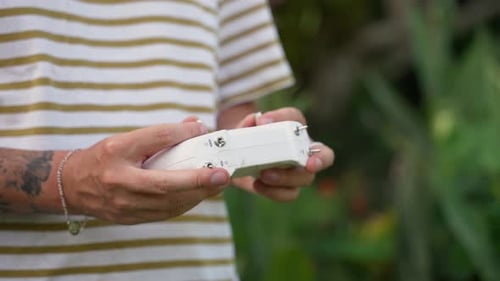 Man Using Drone Remote Control Outdoors in Daytime