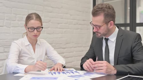 Close Up of Business People Working on Documents