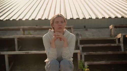 Thoughtful Woman Reflecting on Rustic Stadium Bleachers
