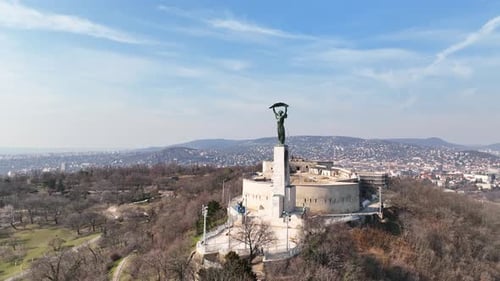 Liberty and freedom statue next to the Buddhist fortress Cittadella with the populous city of Budape