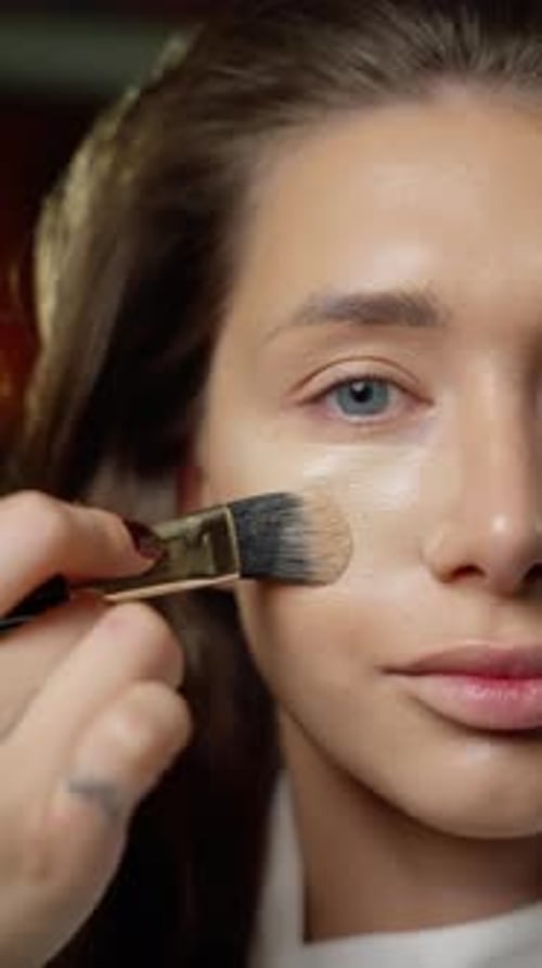 Woman Getting Makeup Applied with Brush Close Up