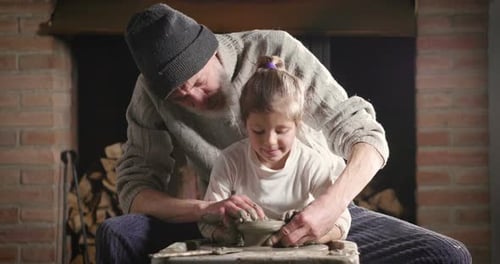 Man and Child Making Pottery Together