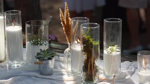 Wedding Party Banquet Outdoors in Forest Dining Table Decorated in Boho Style with Candles White
