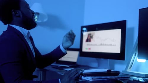 Business African trader investor making stock market analysis video call at office at night