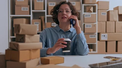 Woman Talking on Phone in Shipping Office