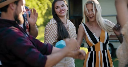 Friends Dancing Together Outside on Sunny Day