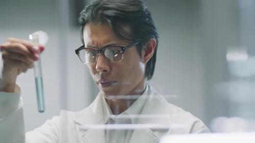 Scientist Analyzes Blue Liquid in Test Tube