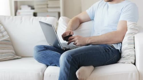 Man Using Laptop for Online Banking at Home