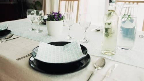Table setting with glassware, plates, and silverware indoors