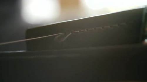 Craftsman Skillfully Stitching Leather with Needle and Thread in Closeup View