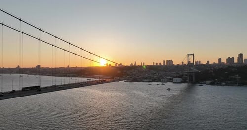 Istanbul Bosphorus Bridge and City Skyline in Background with Turkish Flag at Beautiful Sunset