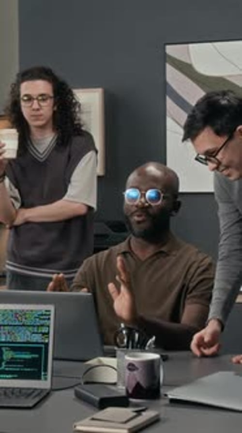 Vertical of Positive IT Specialist Sharing Idea with Two Gen Z Programmers