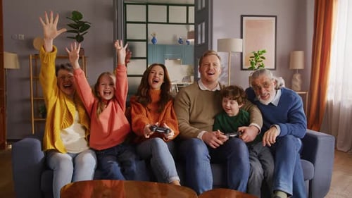 Happy Family Together Playing Video Games at Home