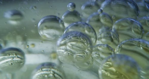 Slow motion macro of micro particles molecules in a liquid are analyzed with microscope for bioche