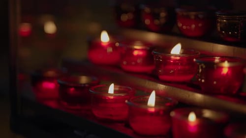 Burning Votive Candles in a Dimly Lit Setting