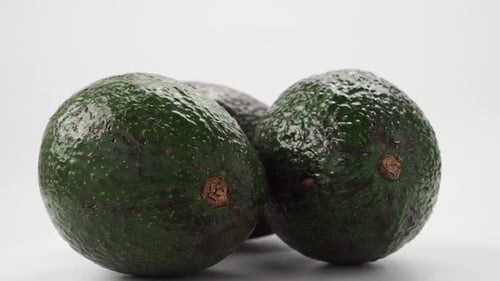 Fresh Green Avocados on a White Background