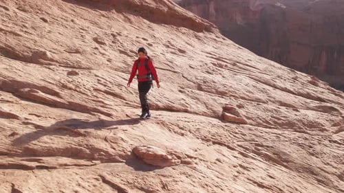 Aerial of a woman hiking through the landscape near Moab