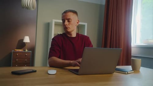 Man Works on Laptop then Uses Smart Phone