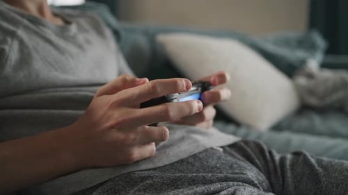 Close Up Hands of Caucasian Young Boy Playing Video Game Using Wireless Controller