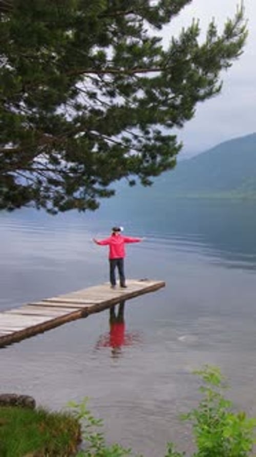Joyful Moment By Peaceful Lake During Calm Afternoon with Breathtaking Mountain Backdrop
