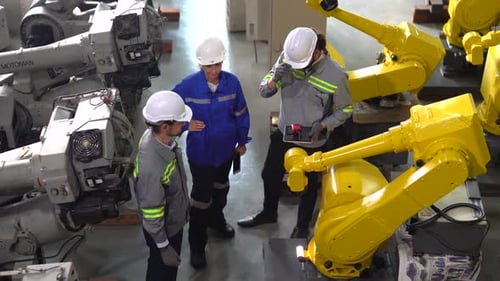 Industrial engineer working at automated AI robotic production factory.