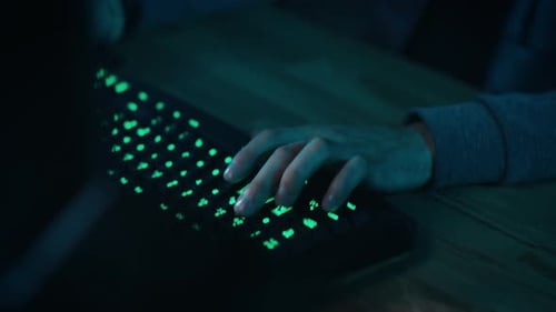 Close Up Hands Shot Showing a Gamer Pushing the Keyboard Buttons while Playing an Online Video Game